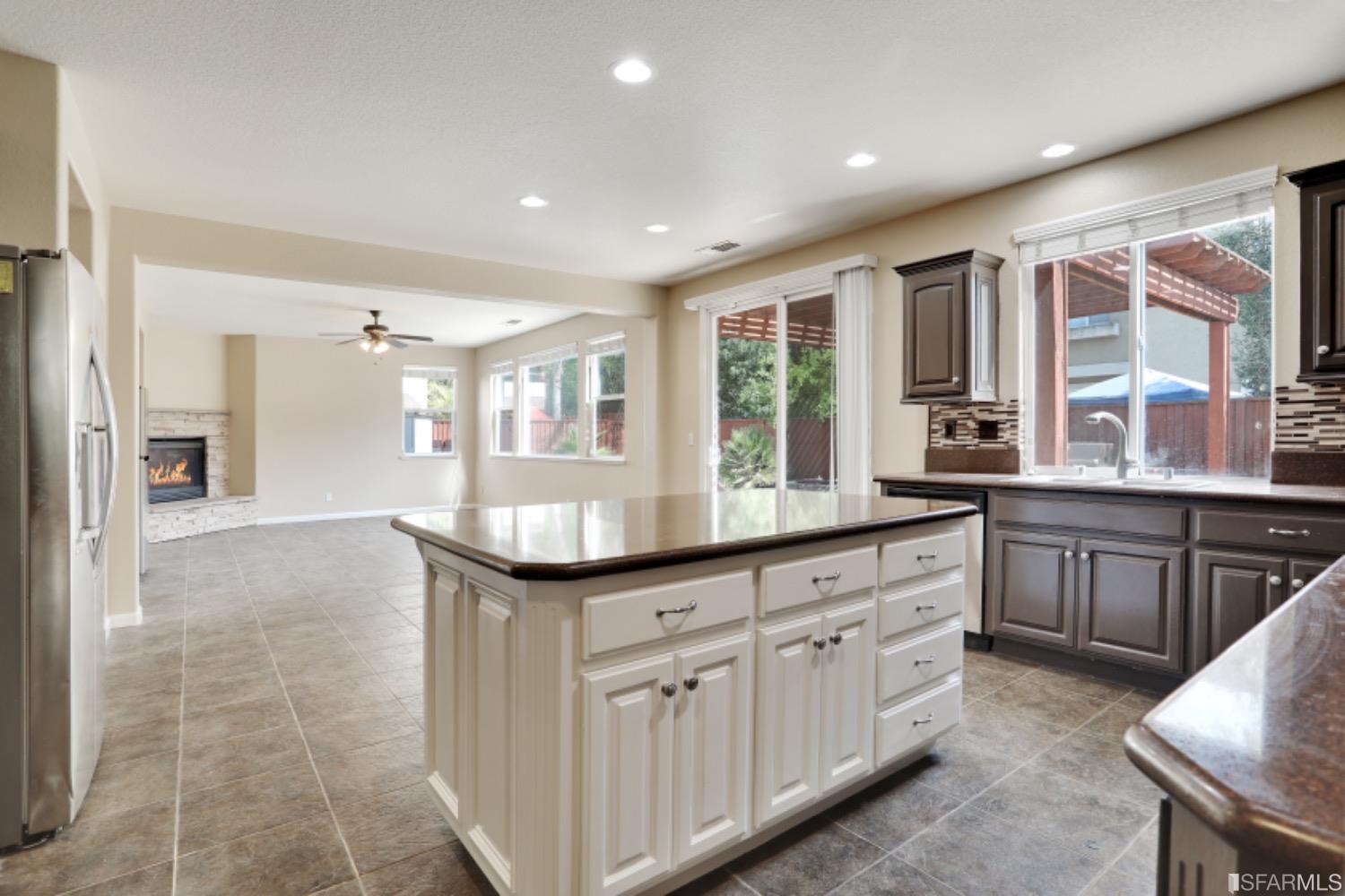 3444 Keystone Loop Discovery Bay, CA 94505 - Photo 7 of 40 a kitchen with granite countertop a sink and cabinets