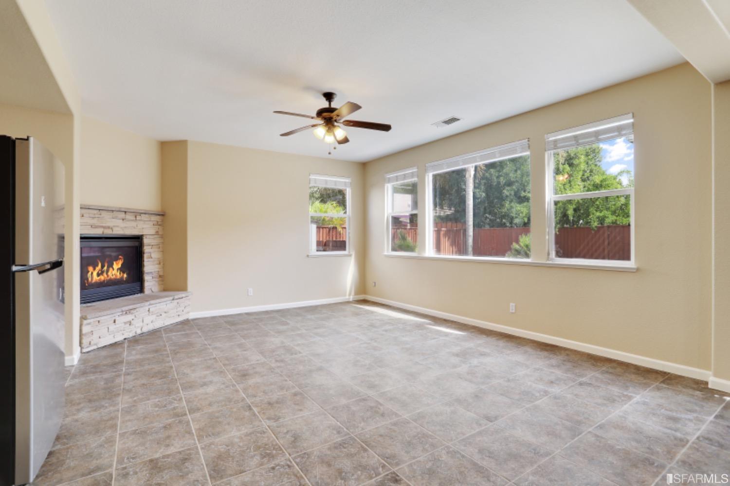 3444 Keystone Loop Discovery Bay, CA 94505 - Photo 10 of 40 a view of an empty room with a fireplace and a window