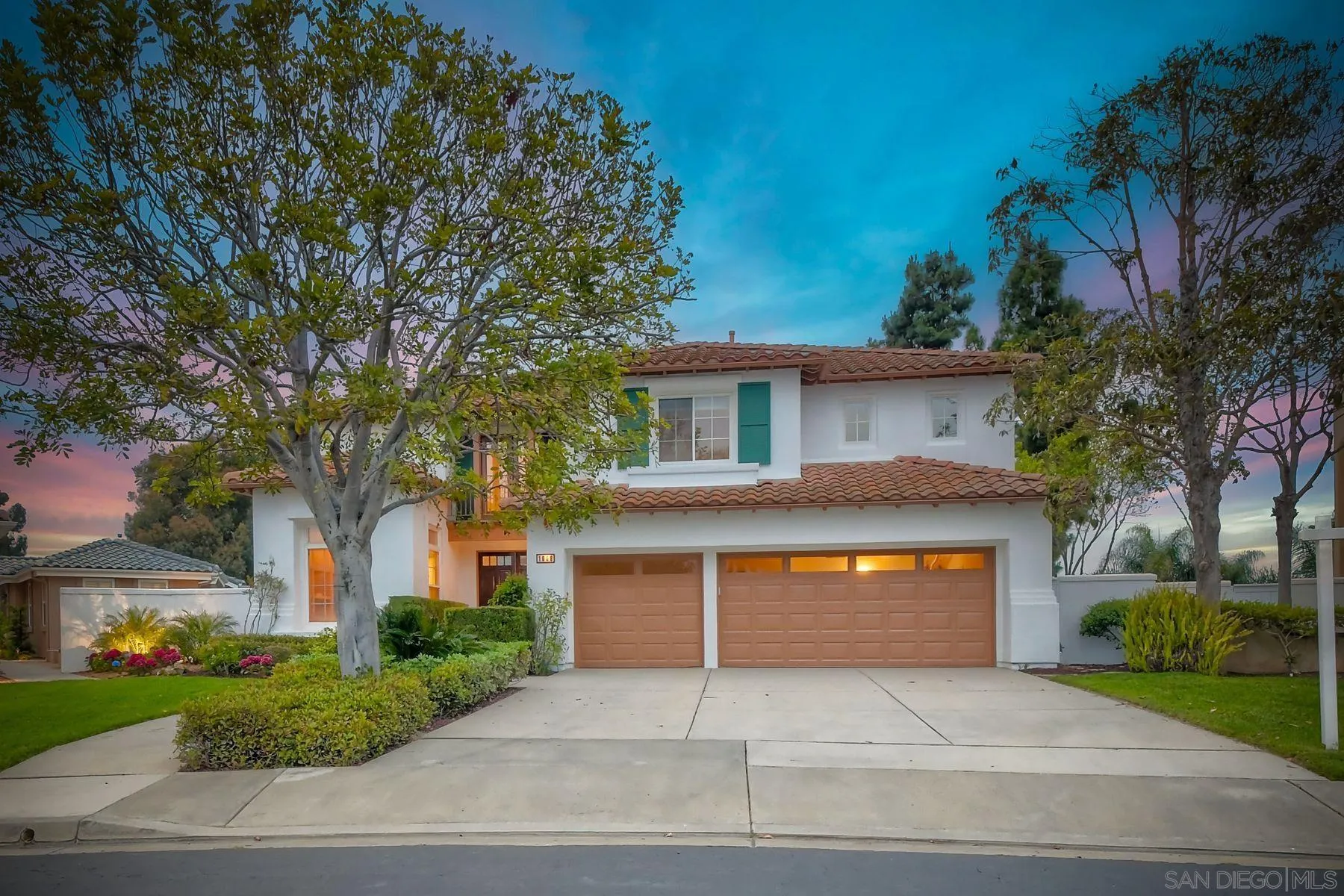 1008 Merganser Lane Carlsbad, CA 92011 - Photo 2 of 2 a front view of a house with a yard and garage