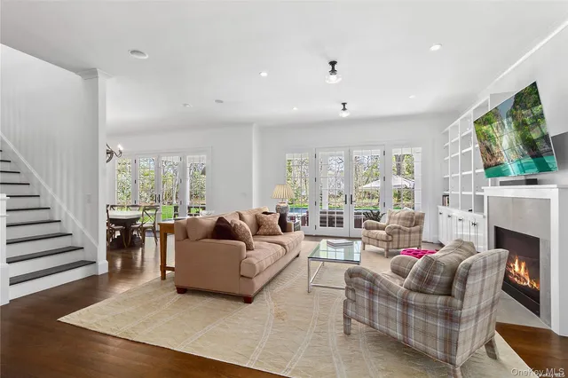 a living room with fireplace furniture and a flat screen tv
