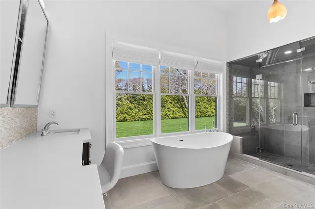 a view of a bathtub & sink in a room