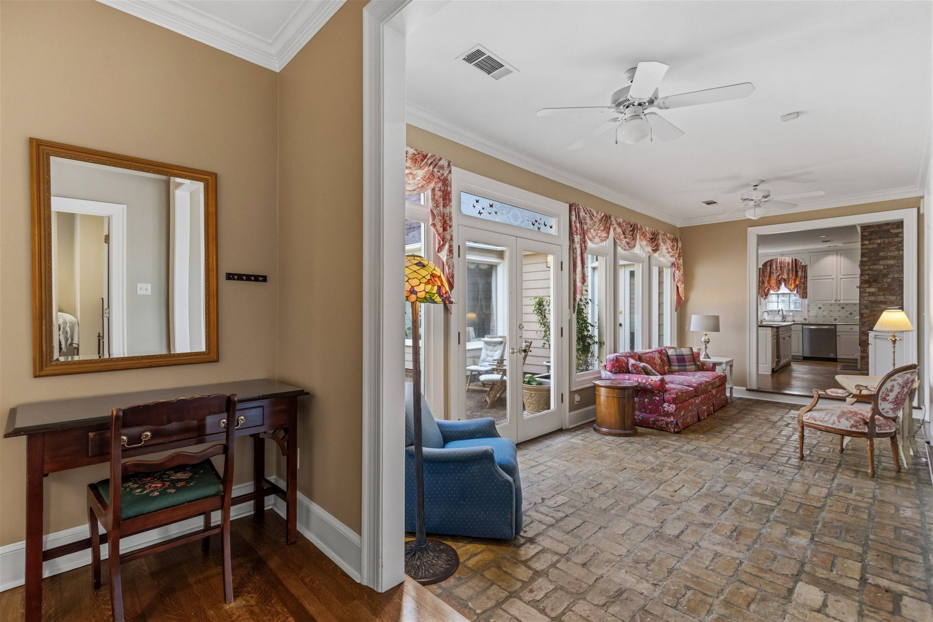 356 North Walnut Bend Road Memphis, TN 38018 - Photo 12 of 37 22x09 Sunroom overlooking rear yard with brick floors, walls of windows, and abundant natural light. Bright and inviting space perfect for relaxing or enjoying morning coffee.