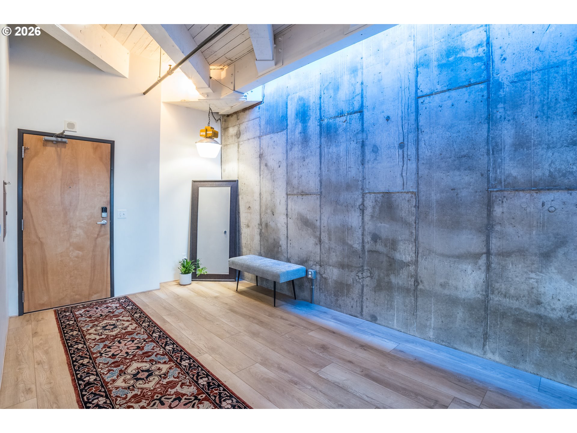 1420 Northwest Lovejoy Street, Unit 417 Portland, OR 97209 - Photo 12 of 40 a bedroom with a bed and a wooden floor