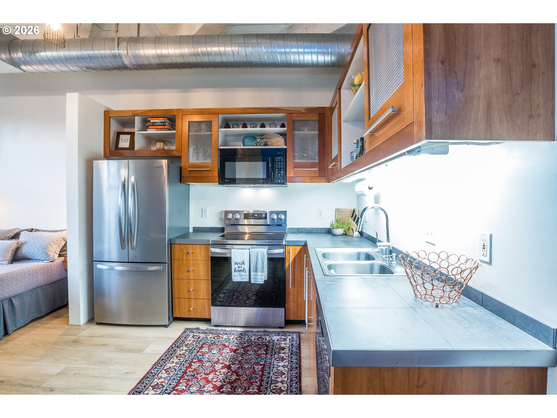 1420 Northwest Lovejoy Street, Unit 417 Portland, OR 97209 - Photo 15 of 40 a kitchen with stainless steel appliances granite countertop a refrigerator and a stove