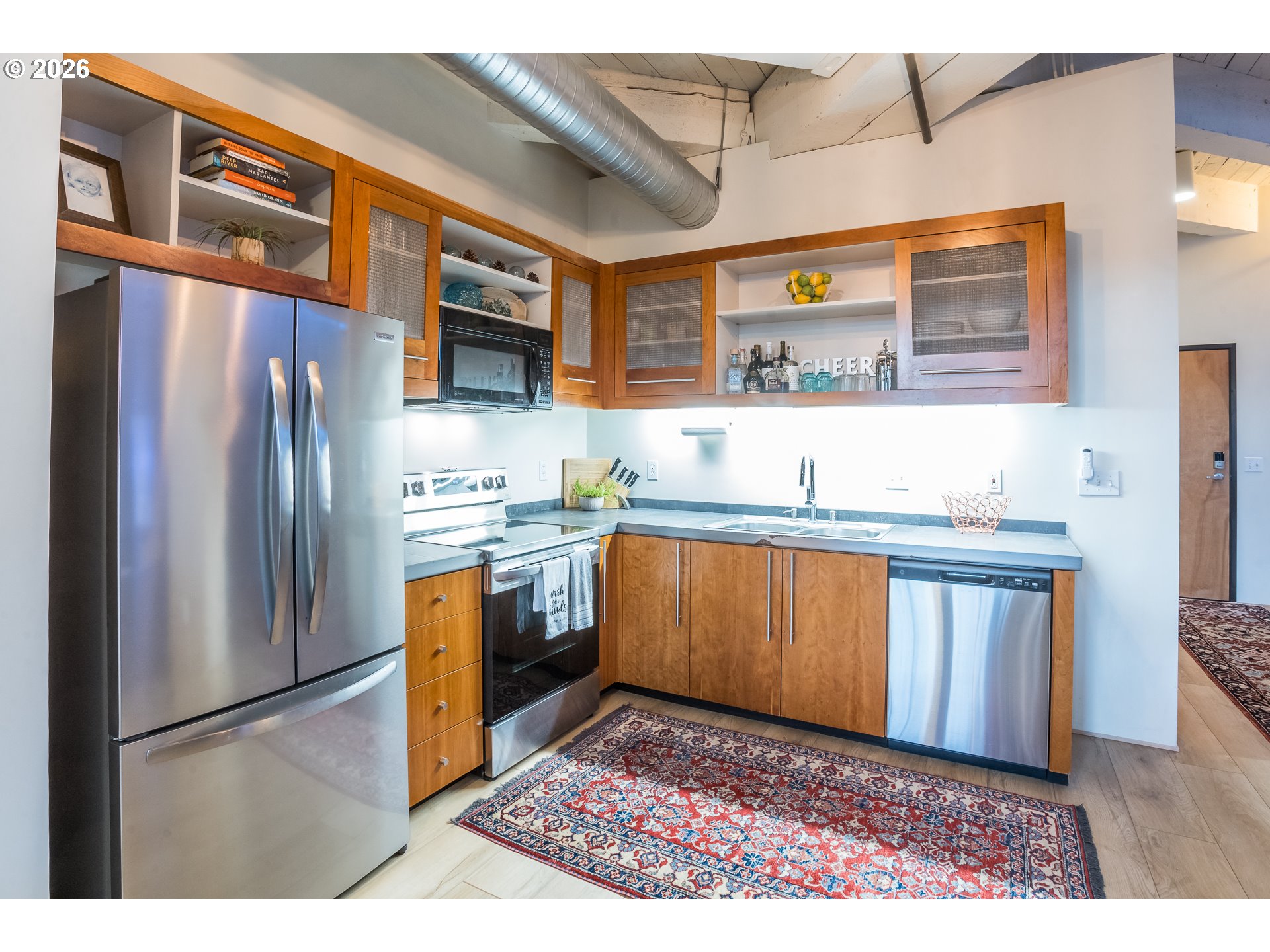 1420 Northwest Lovejoy Street, Unit 417 Portland, OR 97209 - Photo 17 of 40 a kitchen with stainless steel appliances granite countertop a refrigerator a sink and a stove