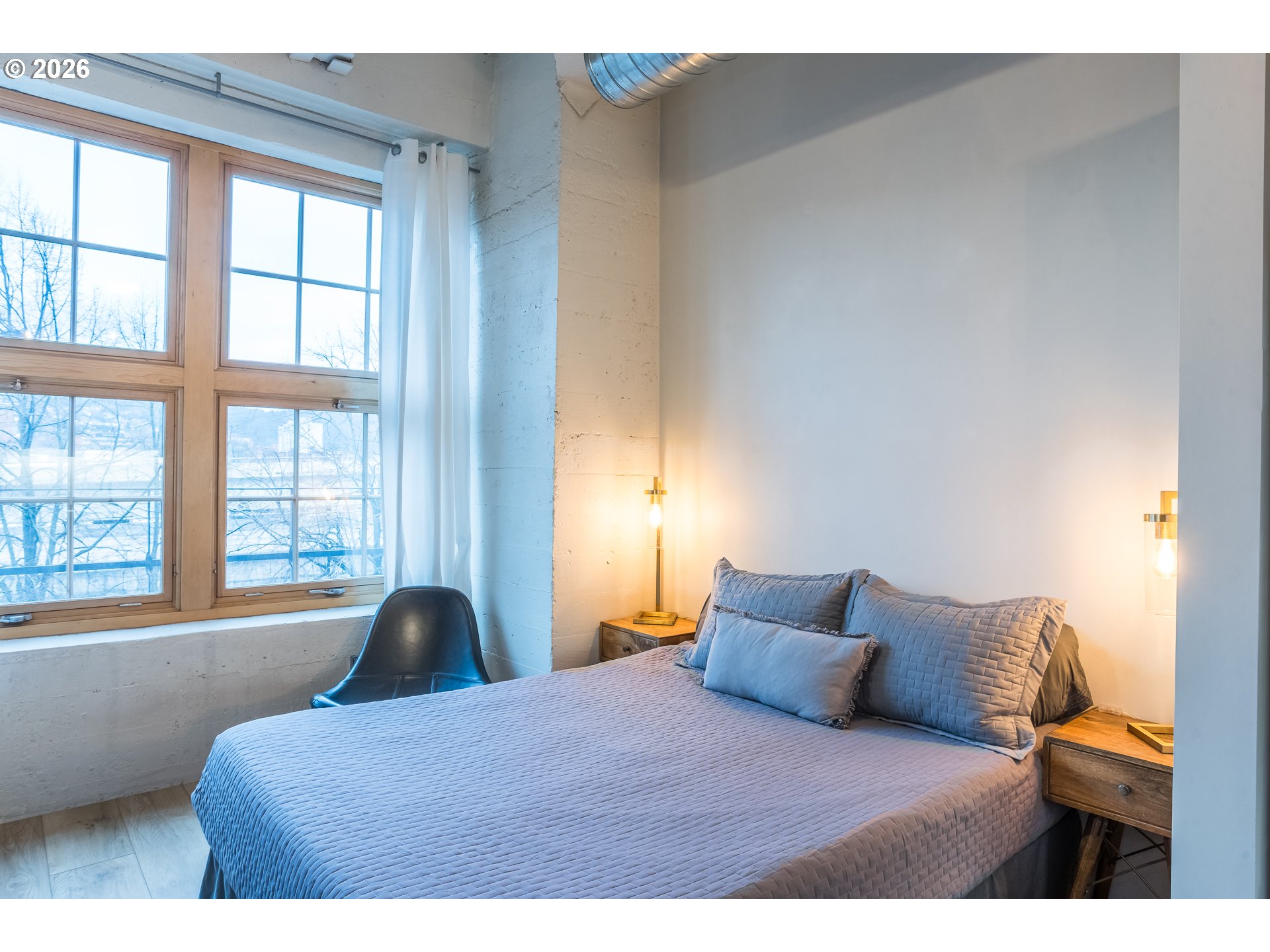 1420 Northwest Lovejoy Street, Unit 417 Portland, OR 97209 - Photo 18 of 40 a bedroom with a bed and a window