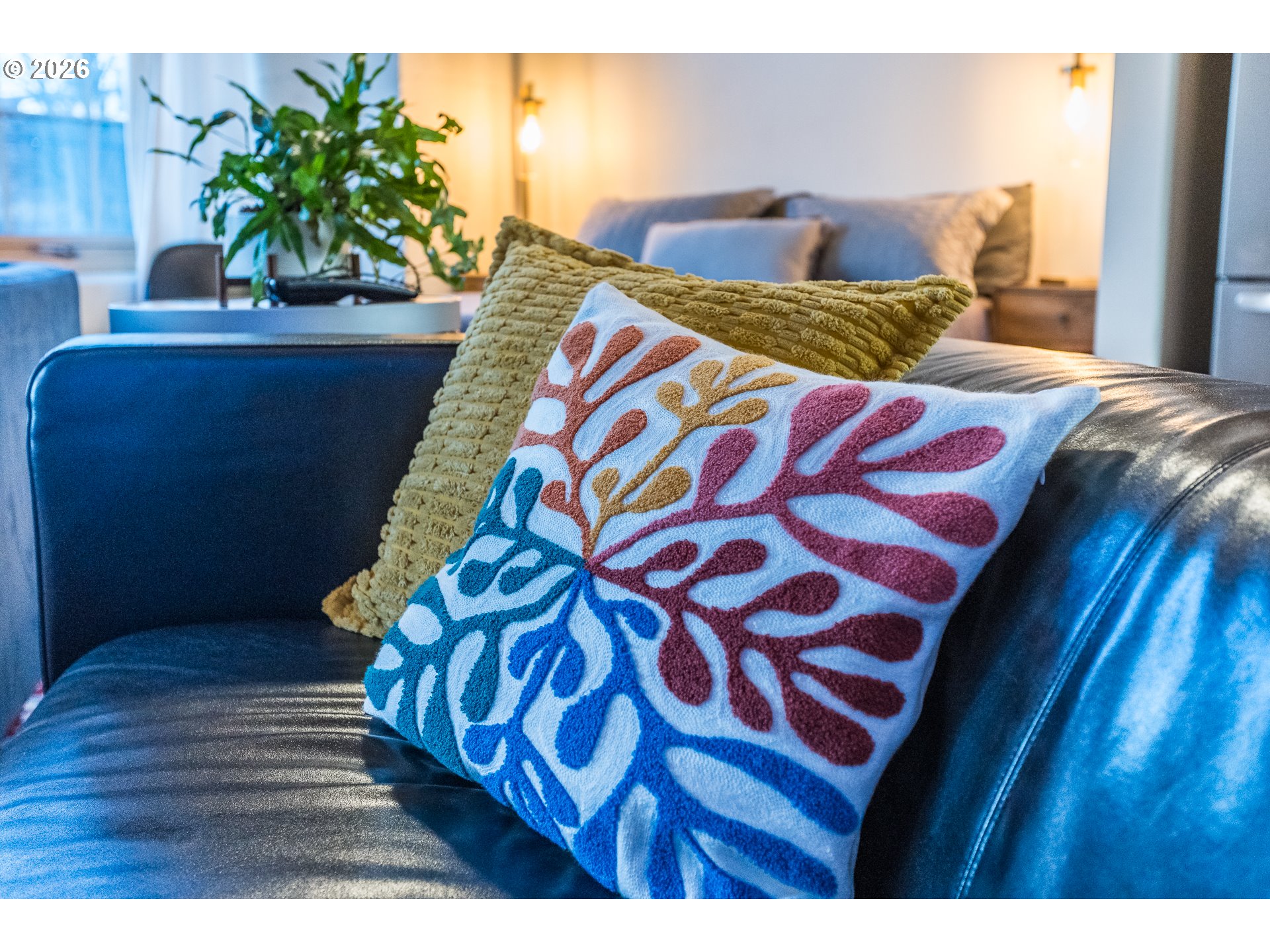 1420 Northwest Lovejoy Street, Unit 417 Portland, OR 97209 - Photo 23 of 40 a bed sitting in a bedroom next to a wooden floor