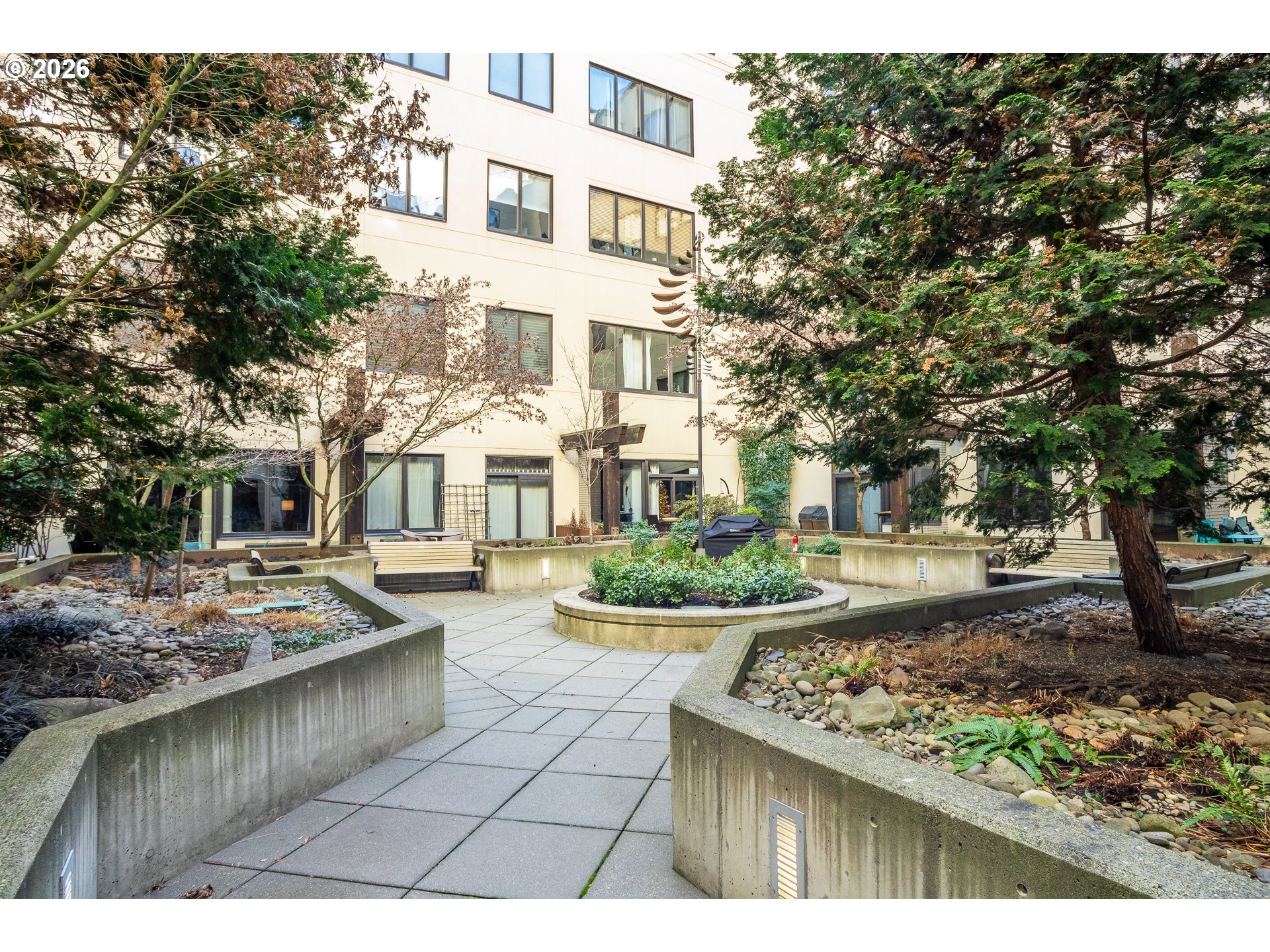 1420 Northwest Lovejoy Street, Unit 417 Portland, OR 97209 - Photo 38 of 40 a view of a patio with table and chairs and potted plants