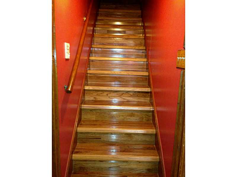 295 9th Avenue Woonsocket, RI 02895 - Photo 14 of 23 Exterior Front. Hardwood stairs leading to finished basement - potential inlaw