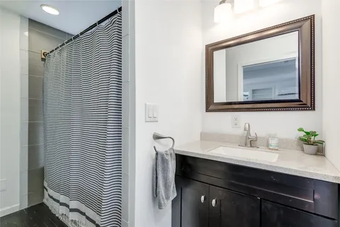 a bathroom with a sink vanity and a mirror