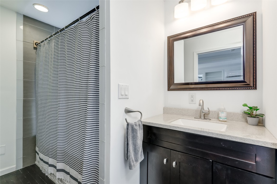 5323 Downs Drive Austin, TX 78721 - Photo 13 of 23 a bathroom with a sink vanity and a mirror