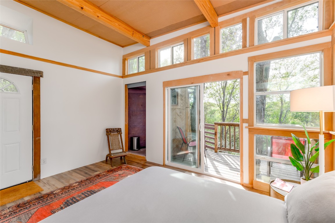 5323 Downs Drive Austin, TX 78721 - Photo 16 of 23 a bedroom with a bed and a large window with balcony view