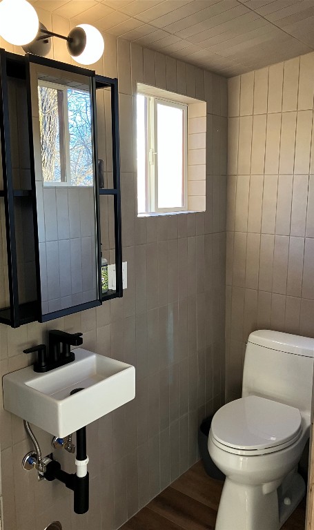 5323 Downs Drive Austin, TX 78721 - Photo 19 of 23 a bathroom with a toilet a sink and a window