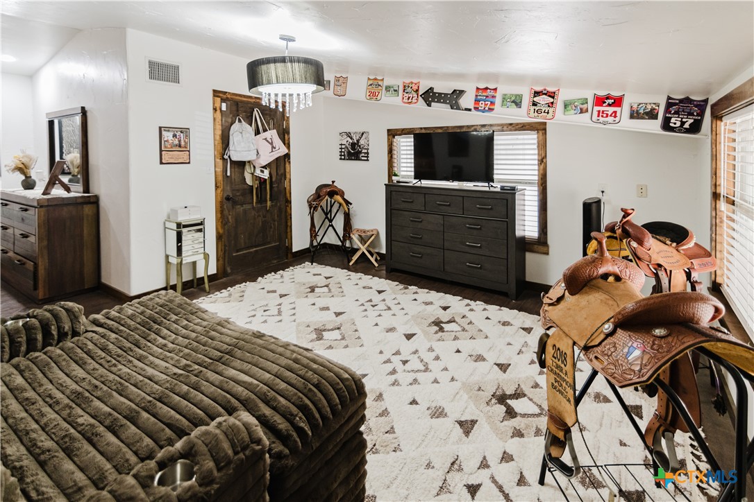 1440 Old Goliad Road Cuero, TX 77954 - Photo 17 of 41 a bedroom with a bed and a tv in it