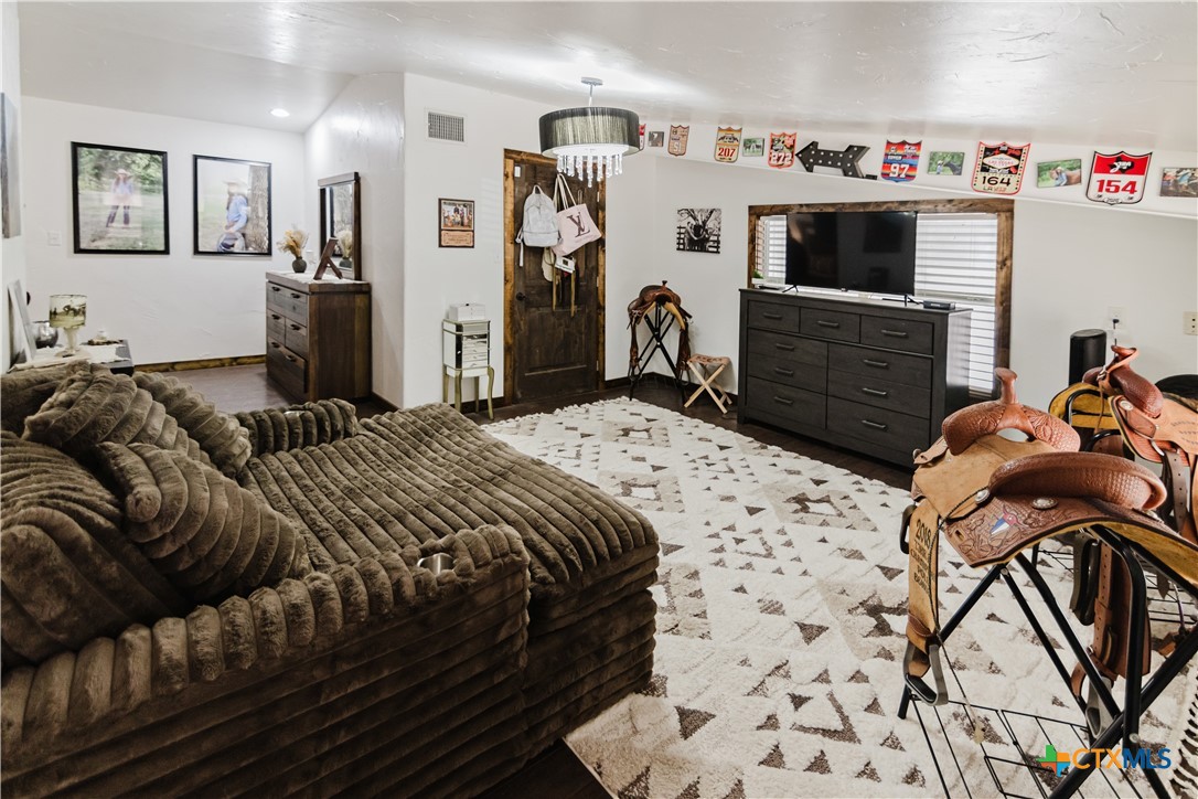 1440 Old Goliad Road Cuero, TX 77954 - Photo 18 of 41 a bedroom with a bed and a flat tv screen on dresser