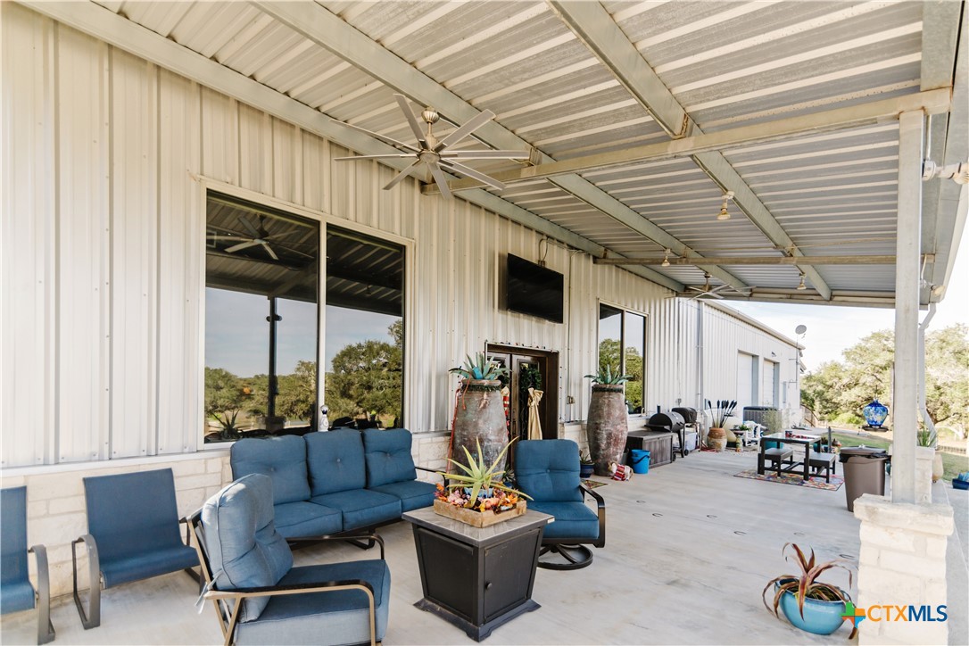 1440 Old Goliad Road Cuero, TX 77954 - Photo 23 of 41 a living room with furniture a fireplace and a table