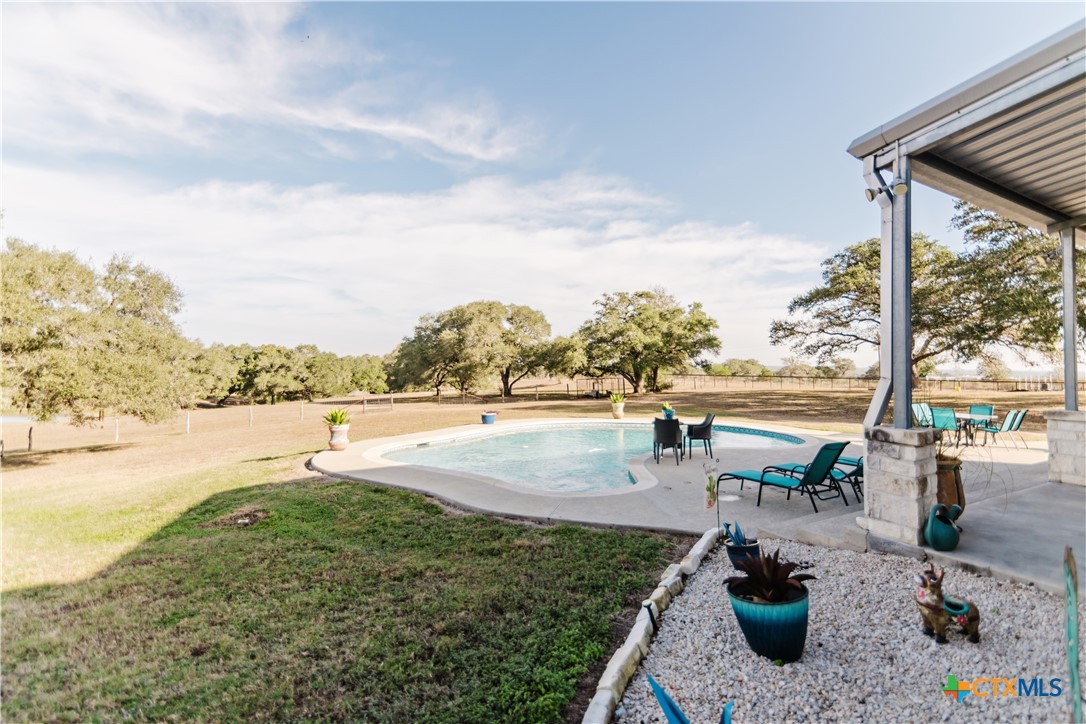 1440 Old Goliad Road Cuero, TX 77954 - Photo 24 of 41 a view of a swimming pool with a patio