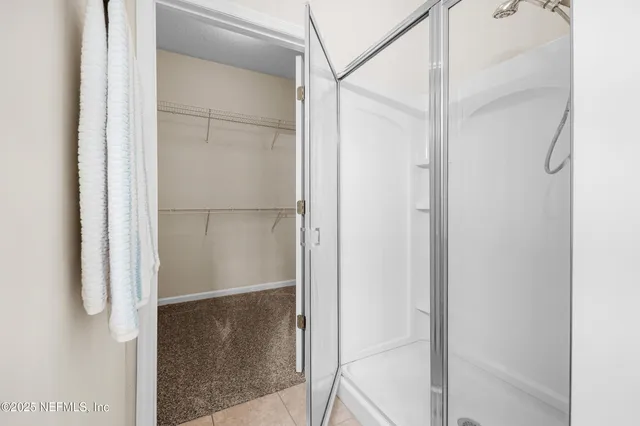 a bathroom with a glass shower door