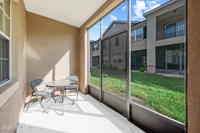 a view of an chair and tables in the balcony