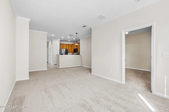 an empty room with a kitchen