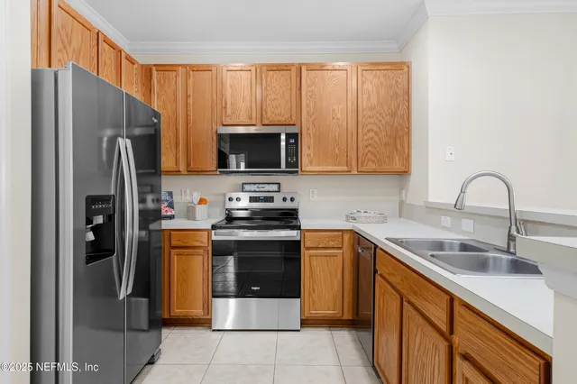 a kitchen with stainless steel appliances granite countertop a refrigerator stove and sink