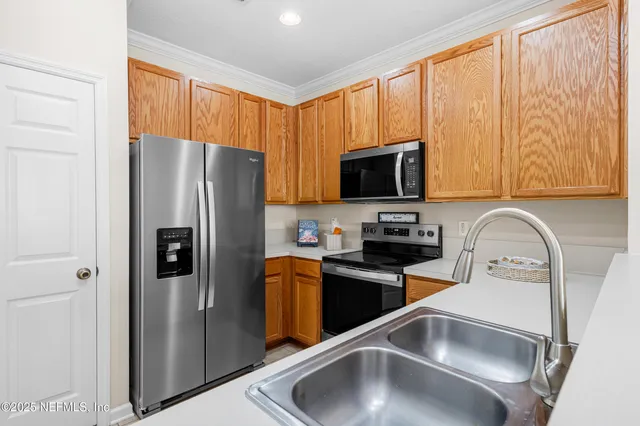 a kitchen with stainless steel appliances granite countertop a refrigerator stove a sink and dishwasher