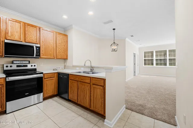 a kitchen with a sink stove and microwave