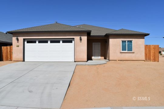 1319 South Farragut Street Ridgecrest, CA 93555 - Photo 1 of 33 a front view of a house with a yard and garage