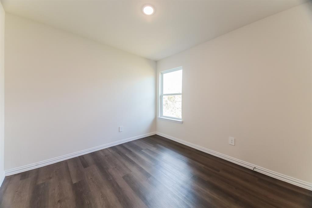 471 Bobbie Street Mabank, TX 75147 - Photo 15 of 21 an empty room with wooden floor and windows