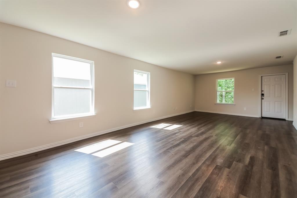 471 Bobbie Street Mabank, TX 75147 - Photo 5 of 21 an empty room with wooden floor and windows