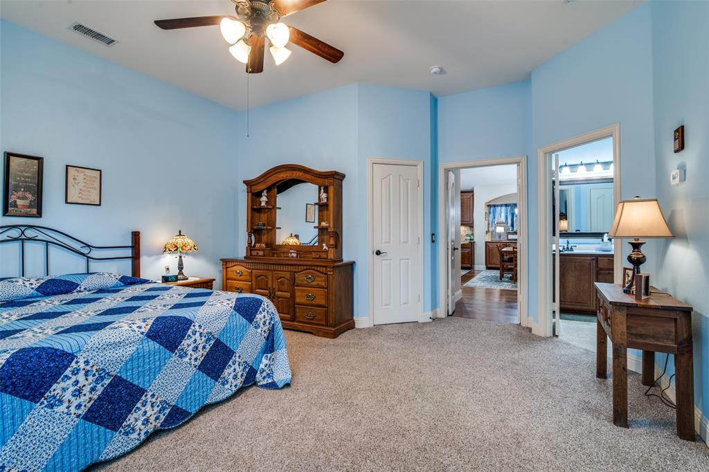 1036 Glenn Road Lavon, TX 75166 - Photo 15 of 30 a bed room with a bed and a chandelier