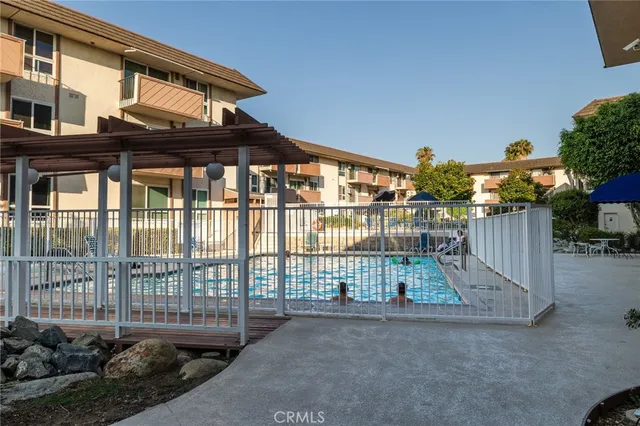 a row of palm trees in front of a building