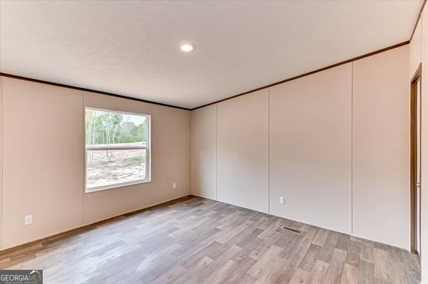 an empty room with a empty space and windows