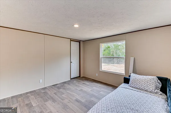 a bedroom with a large bed and a window