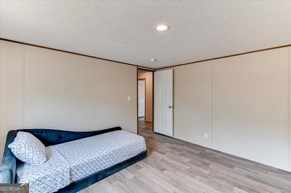 a bedroom with a bed and a ceiling fan