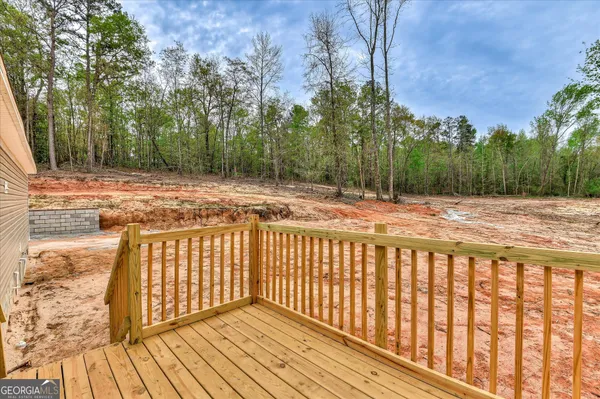 a view of balcony with wooden floor and trees