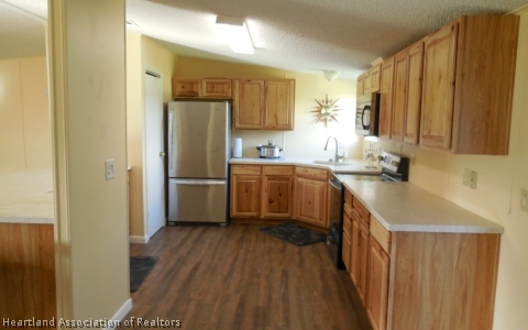 9700 Luther Beck Road Hastings, FL 32145 - Photo 4 of 20 a kitchen with a sink a counter top space stainless steel appliances and cabinets