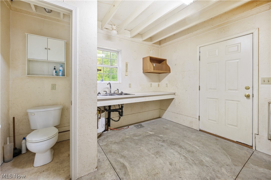 1239 Congress Lake Road Mogadore, OH 44260 - Photo 34 of 35 Bathroom featuring concrete floors, sink, and toilet