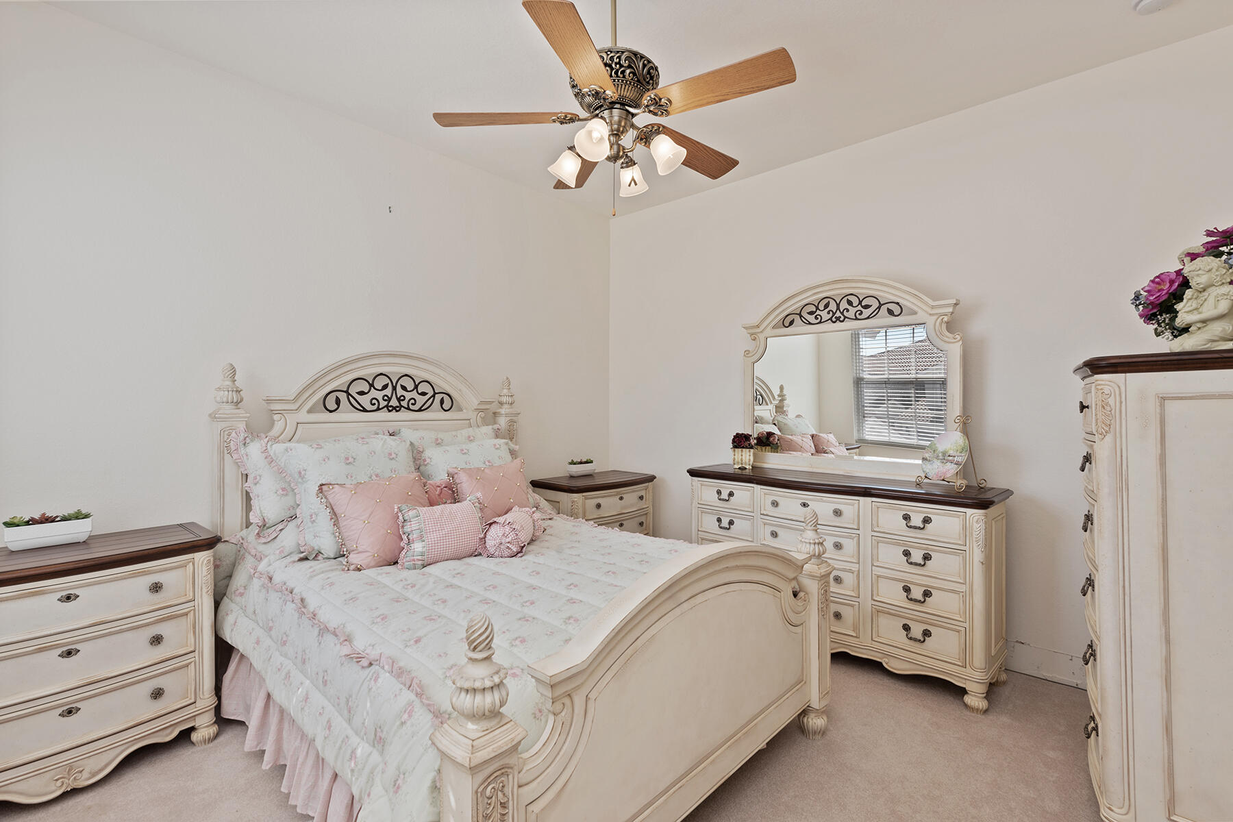 9082 Cascada Way, Unit 202 Naples, FL 34114 - Photo 11 of 37 a bedroom with a bed a chandelier and a dresser