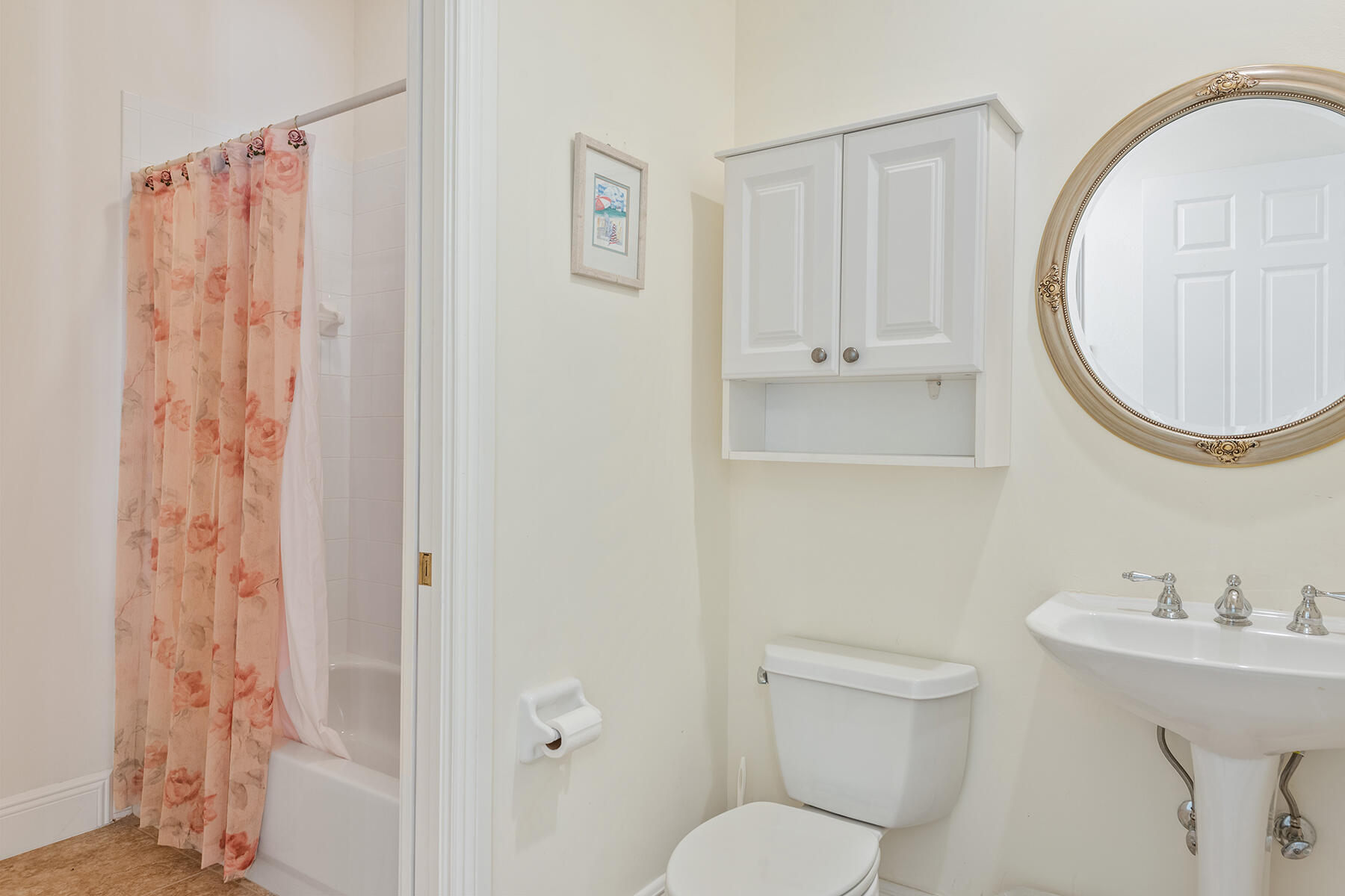 9082 Cascada Way, Unit 202 Naples, FL 34114 - Photo 12 of 37 a bathroom with a toilet a sink and a mirror