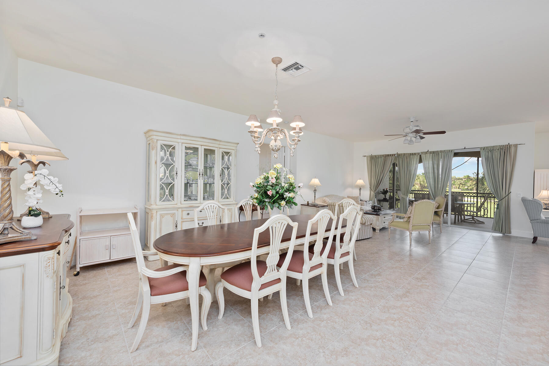 9082 Cascada Way, Unit 202 Naples, FL 34114 - Photo 13 of 37 a dining room with furniture a chandelier and window