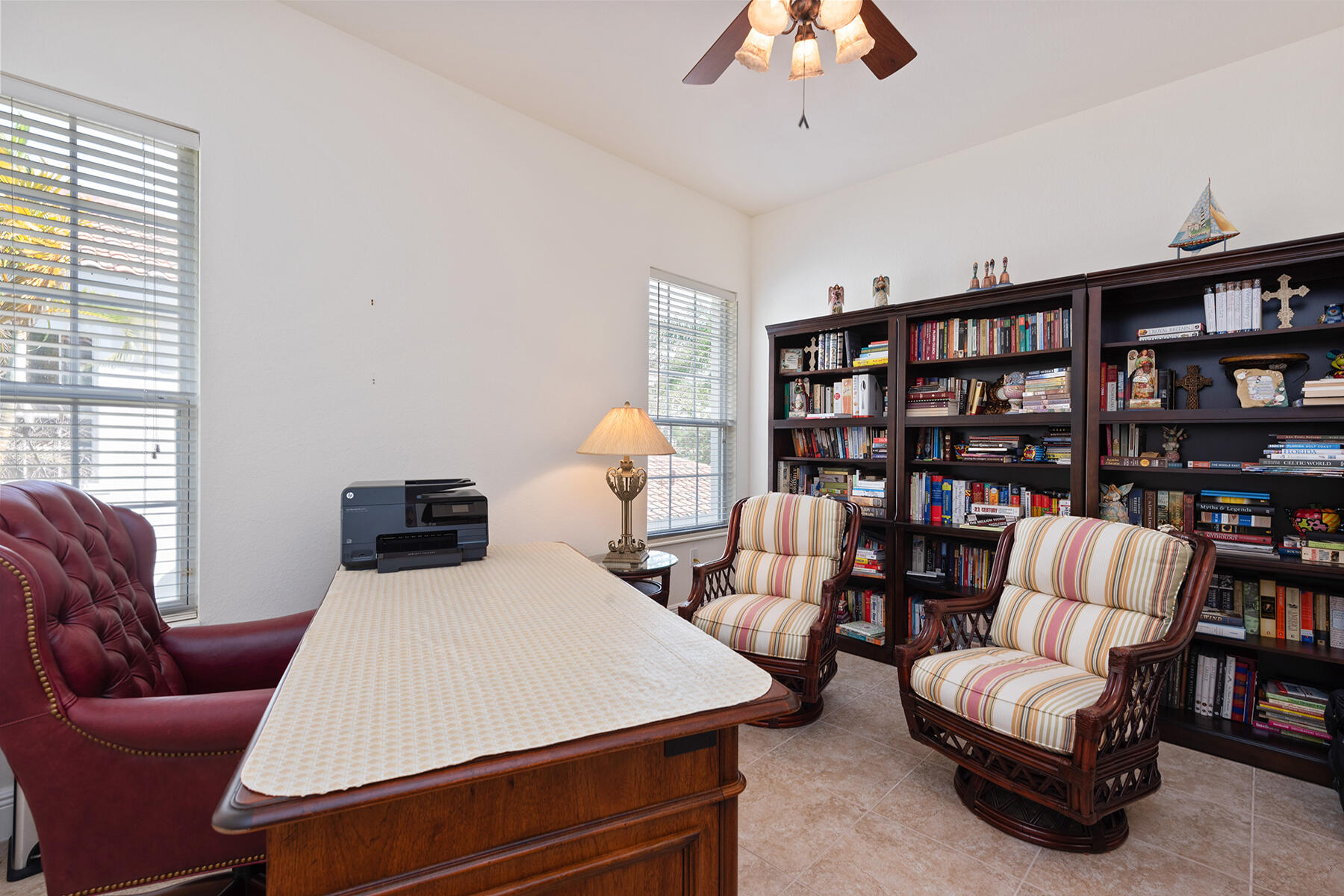 9082 Cascada Way, Unit 202 Naples, FL 34114 - Photo 17 of 37 a living room with furniture a bookshelf and a window