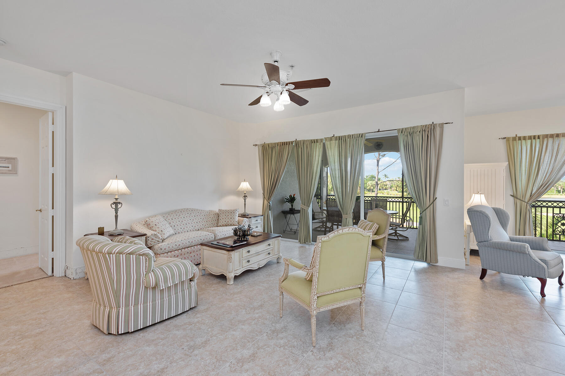 9082 Cascada Way, Unit 202 Naples, FL 34114 - Photo 2 of 37 a living room with furniture and a large window