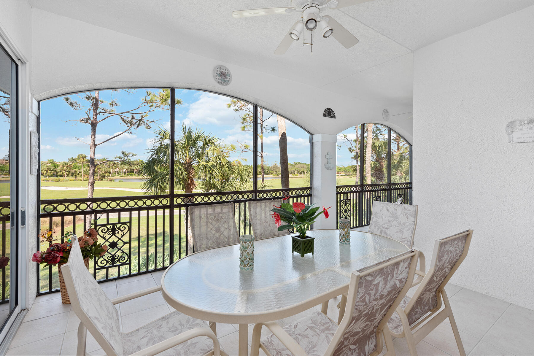 9082 Cascada Way, Unit 202 Naples, FL 34114 - Photo 23 of 37 a view of a dining room with furniture a chandelier and wooden floor