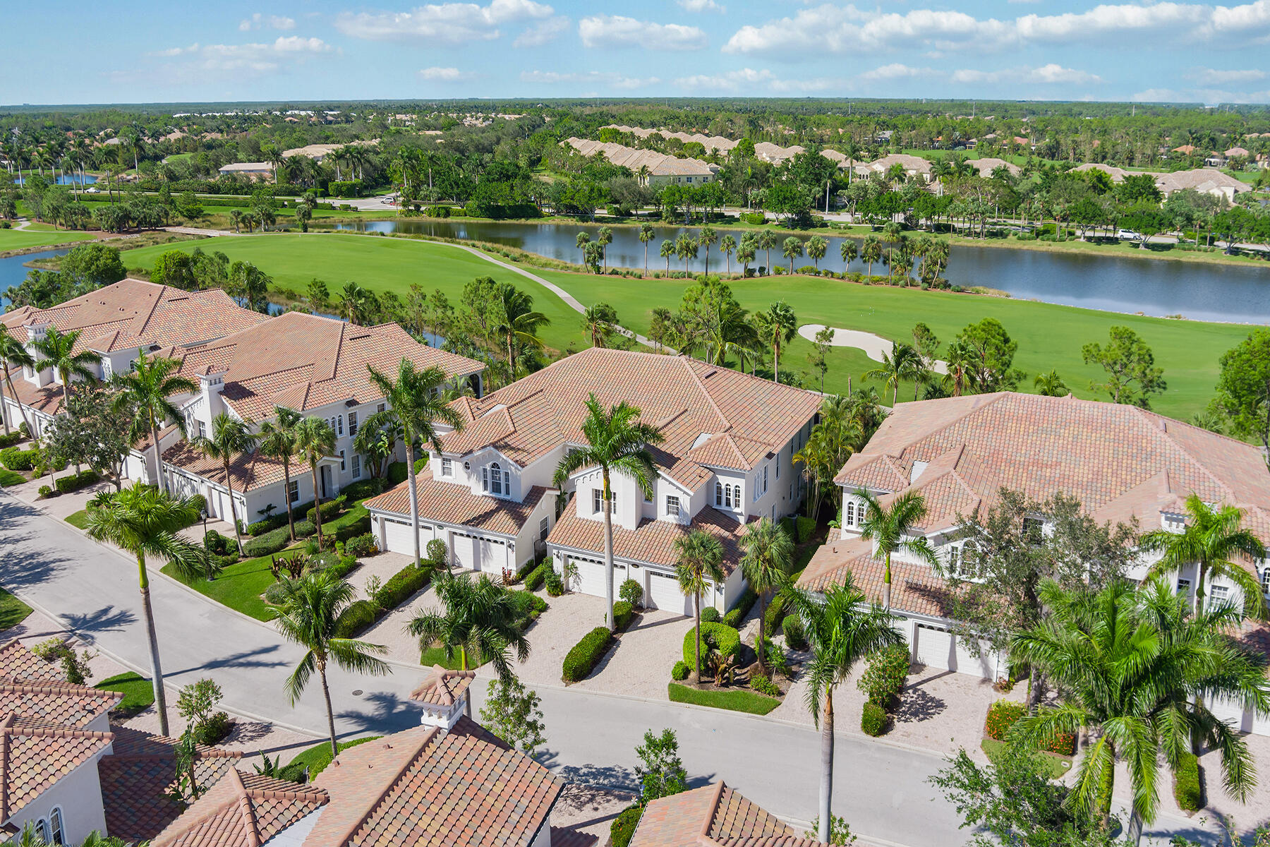 9082 Cascada Way, Unit 202 Naples, FL 34114 - Photo 25 of 37 an aerial view of a house with a garden and lake view