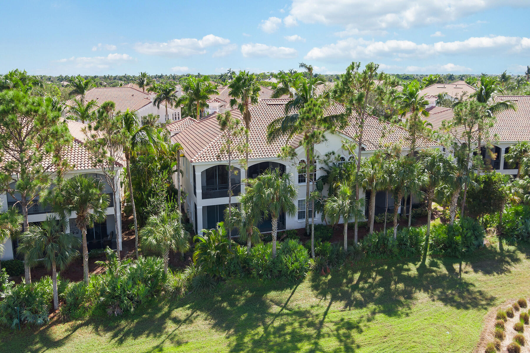 9082 Cascada Way, Unit 202 Naples, FL 34114 - Photo 27 of 37 a view of a garden with a building in the background
