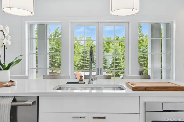 a kitchen with a sink and large window