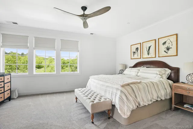 a bedroom with a large bed and a window