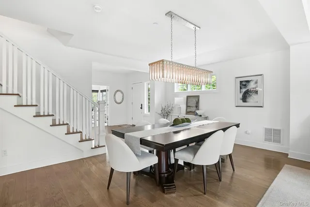 a view of a a dining room with furniture window and wooden floor