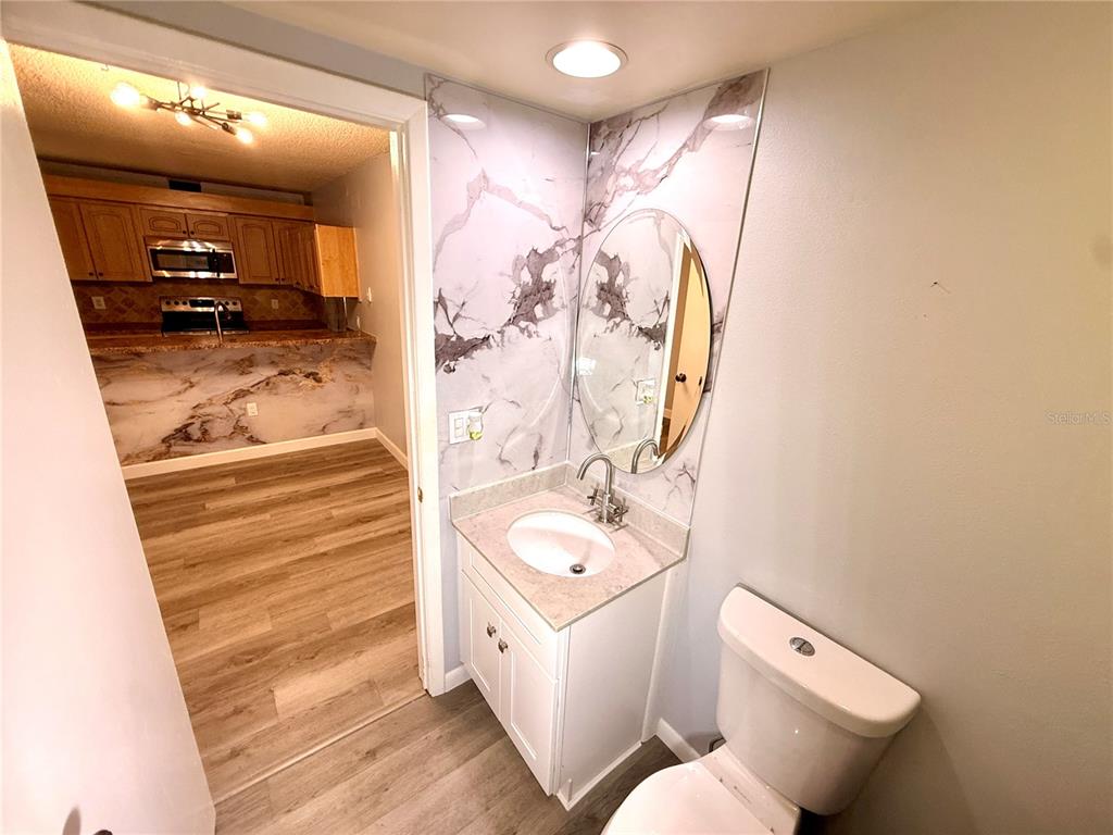 2727 14th Court Palm Harbor, FL 34684 - Photo 13 of 42 a bathroom with a toilet sink and mirror